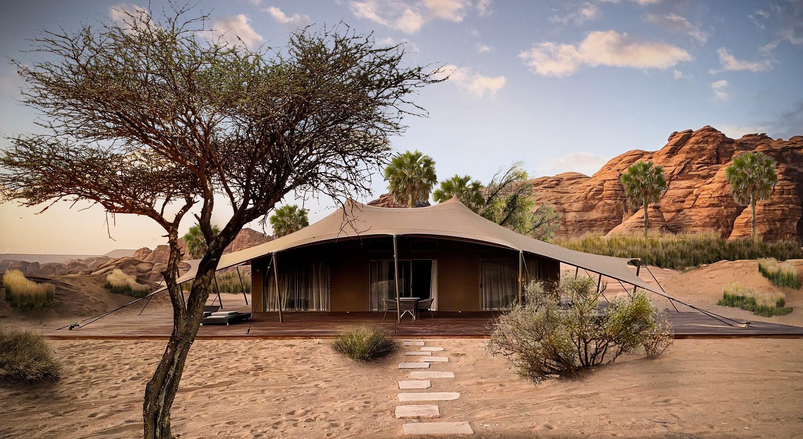 Naturalistic landscaping around a banyan tree and tented accommodation at Wadi Ashar in AlUla